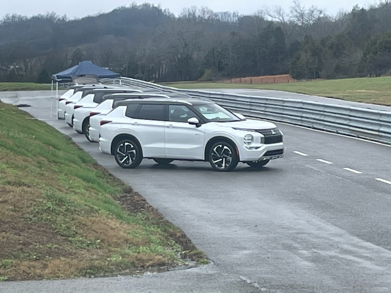  a group of white Mitsubishi Outlander PHEVs