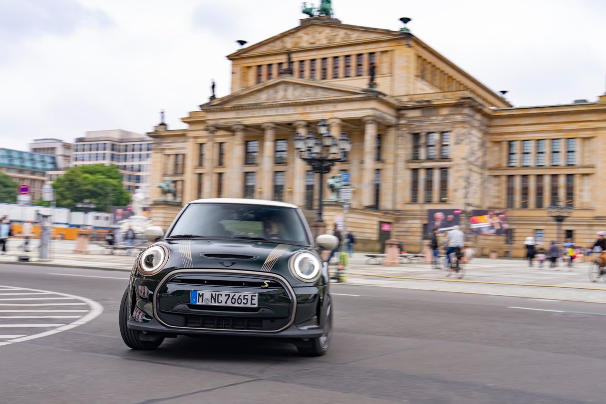 A Mini Cooper driving around city streets.