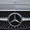 A Mercedes-Benz logo on the front of a car.