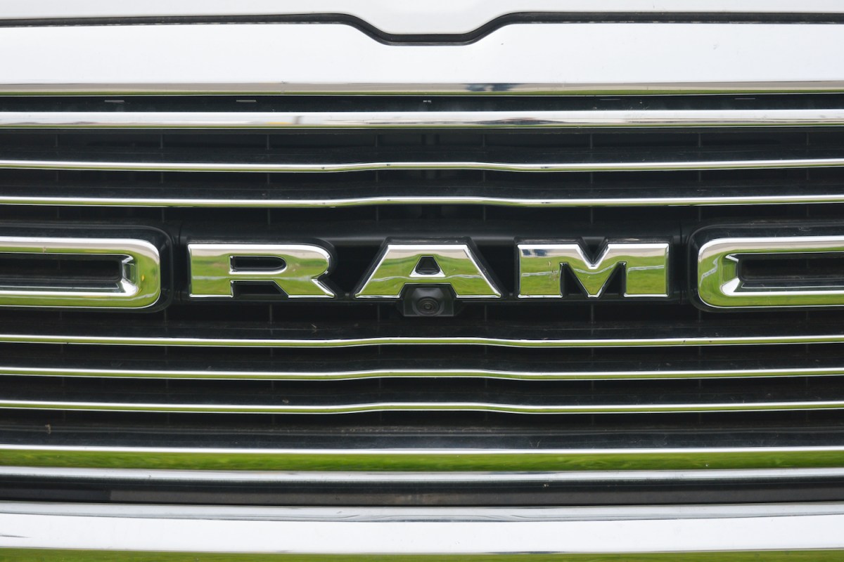 Closeup of the chrome grille of a pickup truck, the work RAM visible.