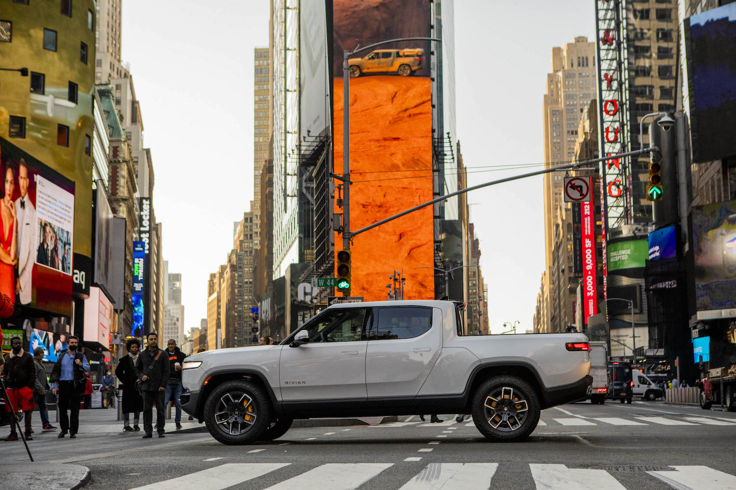 White Rivian R1T electric pickup truck parked in Times Square, New York City for the company's Wall Street stock exchange IPO.