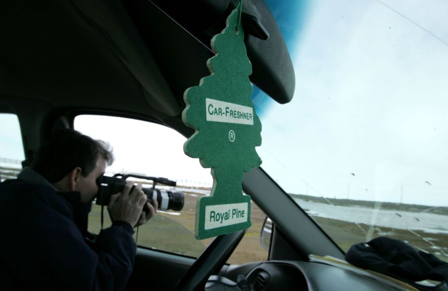 A green Royal Pine car air freshener hanging from a rearview mirror seen in Browerville, Alaska