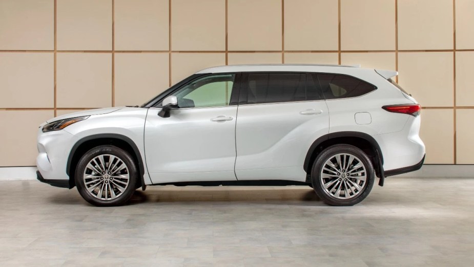 Side view of white 2023 Toyota Highlander midsize SUV