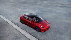 This red 2022 Tesla Model 3 boasts a Long Range trim.