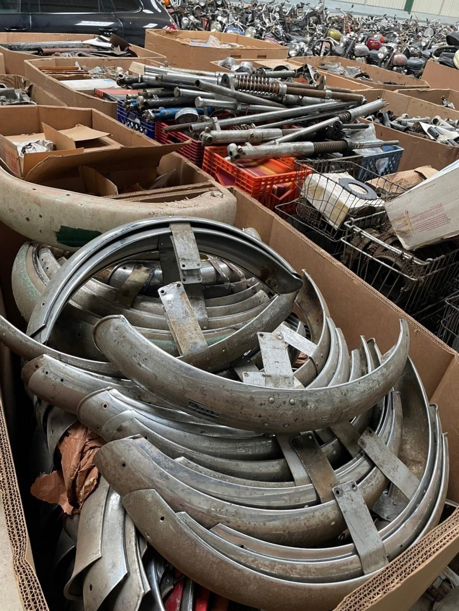 piles of vintage British motorcycle parts