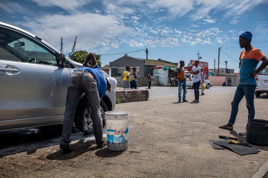 A car wash place using buckets to wash cars.