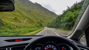 A driver's view while driving down the road.