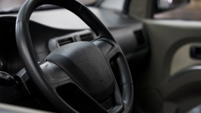 A black steering wheel. Potentially one a steering wheel shaking.