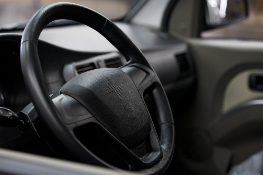 A black steering wheel. Potentially one a steering wheel shaking. 