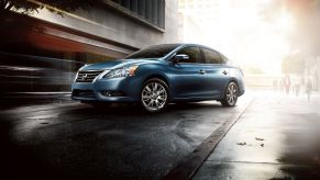 A teal/light blue 2015 Nissan Sentra compact sedan model