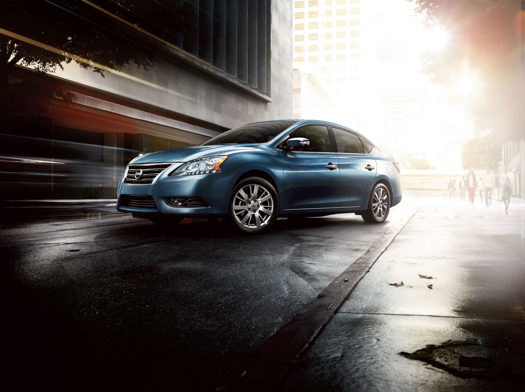 A teal/light blue 2015 Nissan Sentra compact sedan model