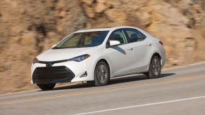 A white Toyota Corolla compact sedan from the 2017-2018 model year generation