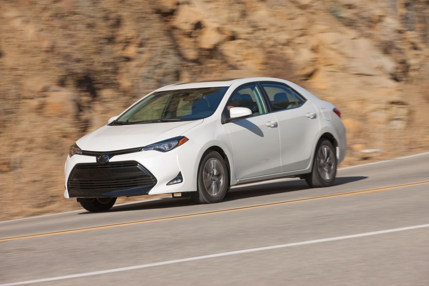 A white Toyota Corolla compact sedan from the 2017-2018 model year generation