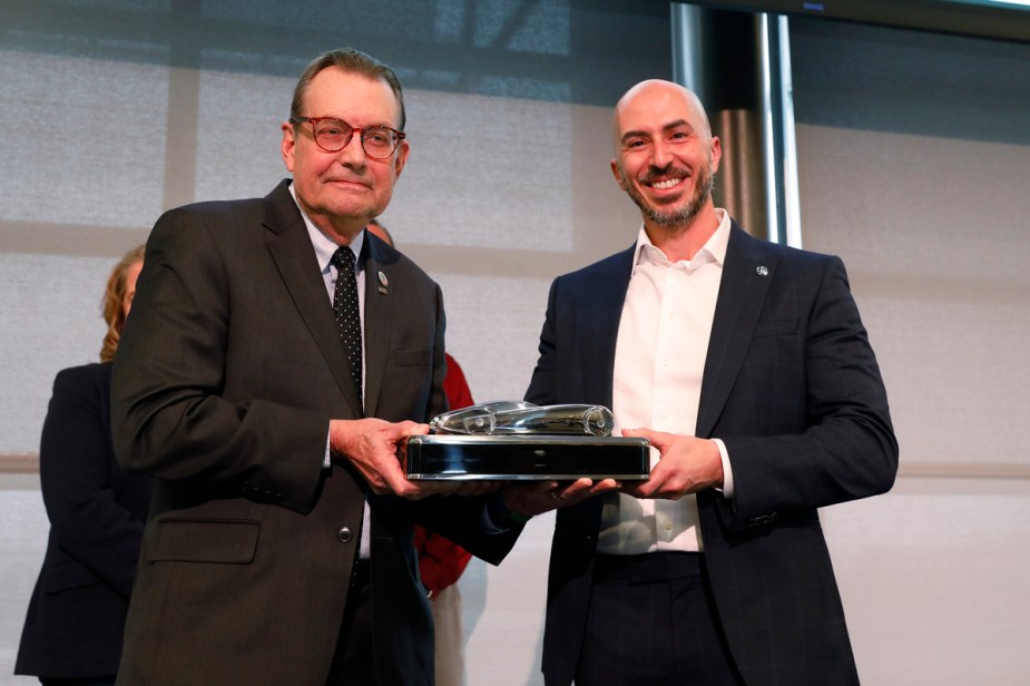 Emile Korkor, assistant vice president of Acura National Sales accepts the award presented by Jack Nerad.