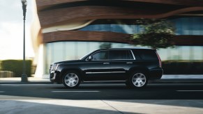 A 2015 Cadillac Escalade driving on the road