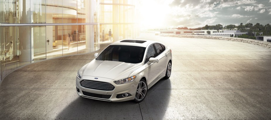 A white 2015 Ford Fusion parked outdoors. 