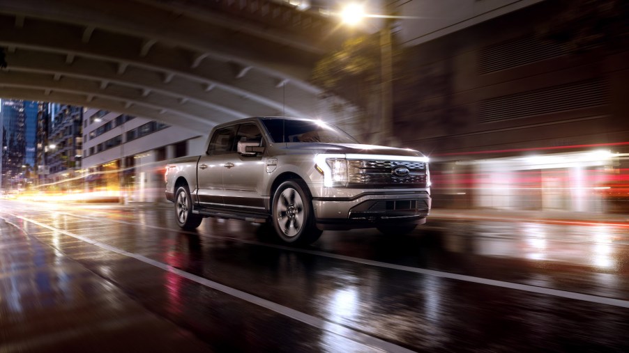 2022 Ford F-150 Lightning Platinum on a wet road at night