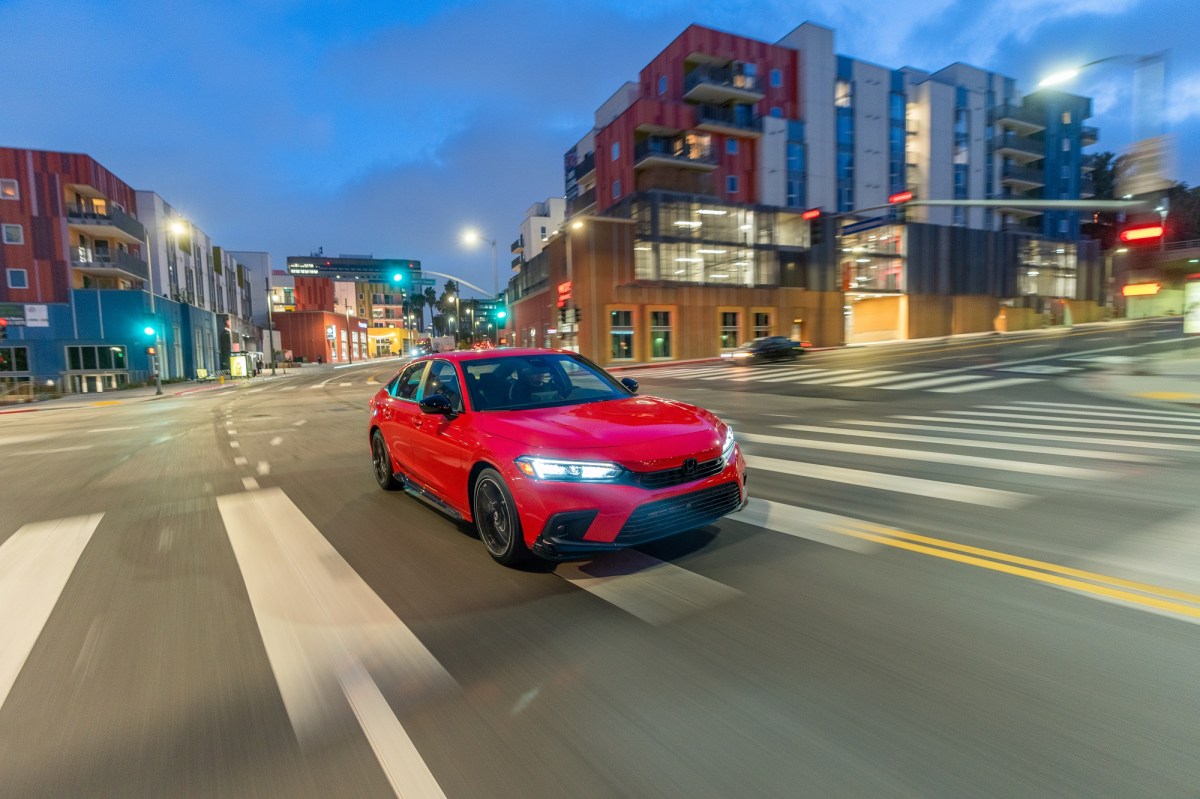 The 2023 Honda Civic, despite being Honda's cheapest car, looks composed driving down city streets at night.