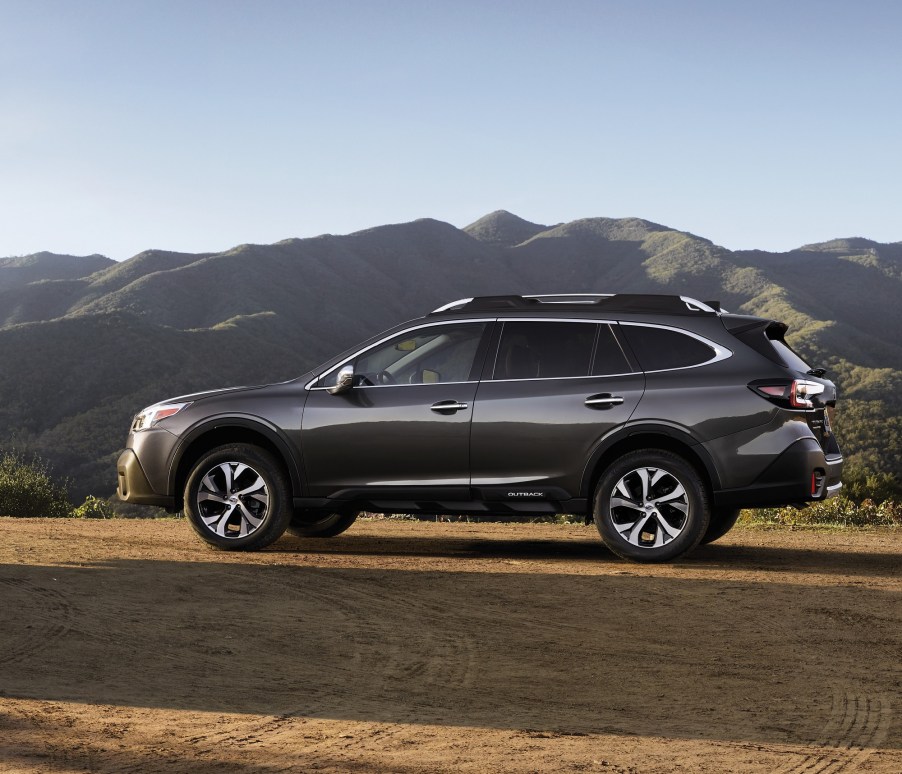 The 2022 Subaru Outback in black on a desert road. The Outback vs. Forester debate is a big one.