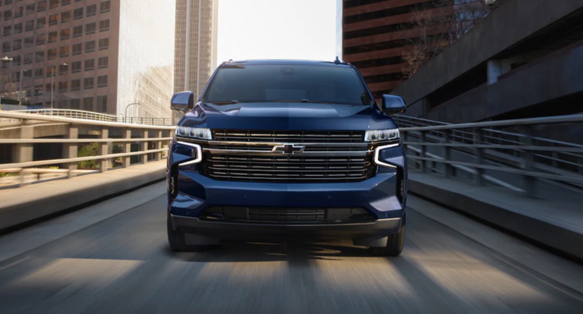 A 2023 Chevy Tahoe driving down a road directly at the camera.