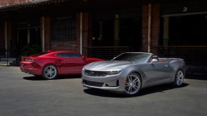 A pair of V8 2023 Chevrolet Camaro LT1s and SS' pose for a picture while parked.