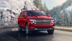 A red 2023 Chevrolet Suburban full-size SUV is parked.