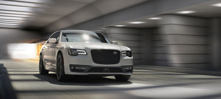 A white 2023 Chrysler 300C full-size executive car/luxury sedan model driving through a tunnel