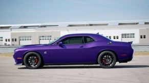 A Plum Crazy Purple 2023 Dodge Challenger shows off its side profile.