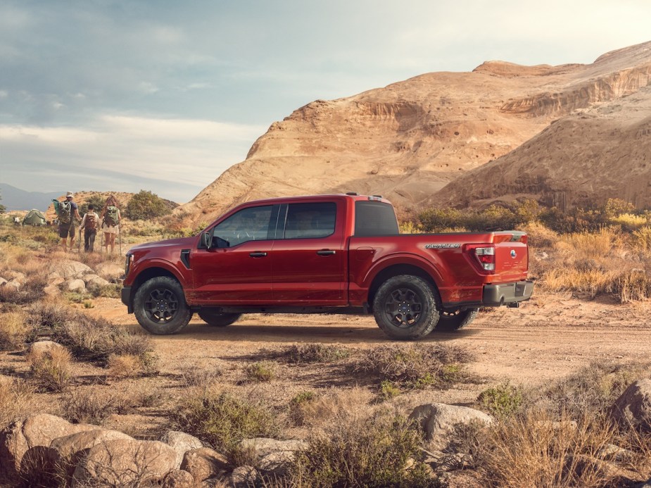 A red Ford F-150 parked in the desert, which is one of the fastest full-size trucks. 