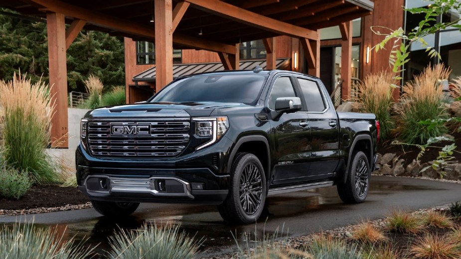 Black 2023 GMC Sierra 1500 posed in front of a home