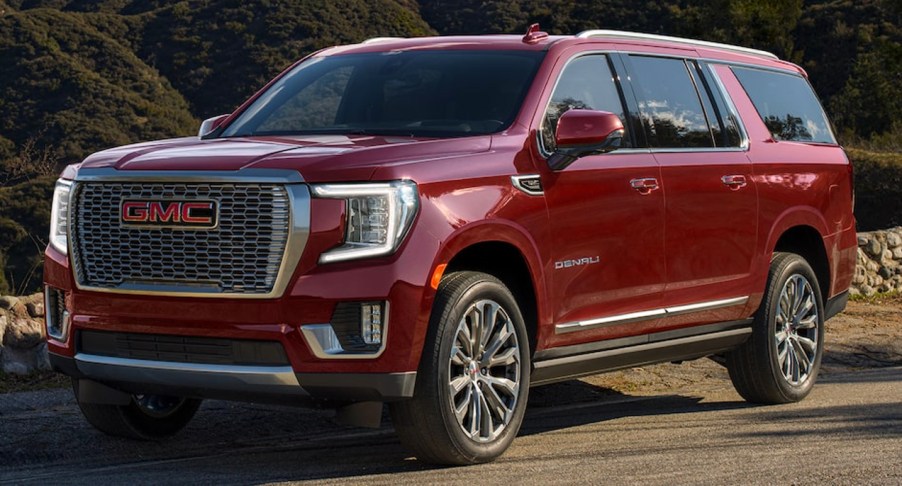 A red 2023 GMC Yukon XL full-size SUV is parked | General Motors