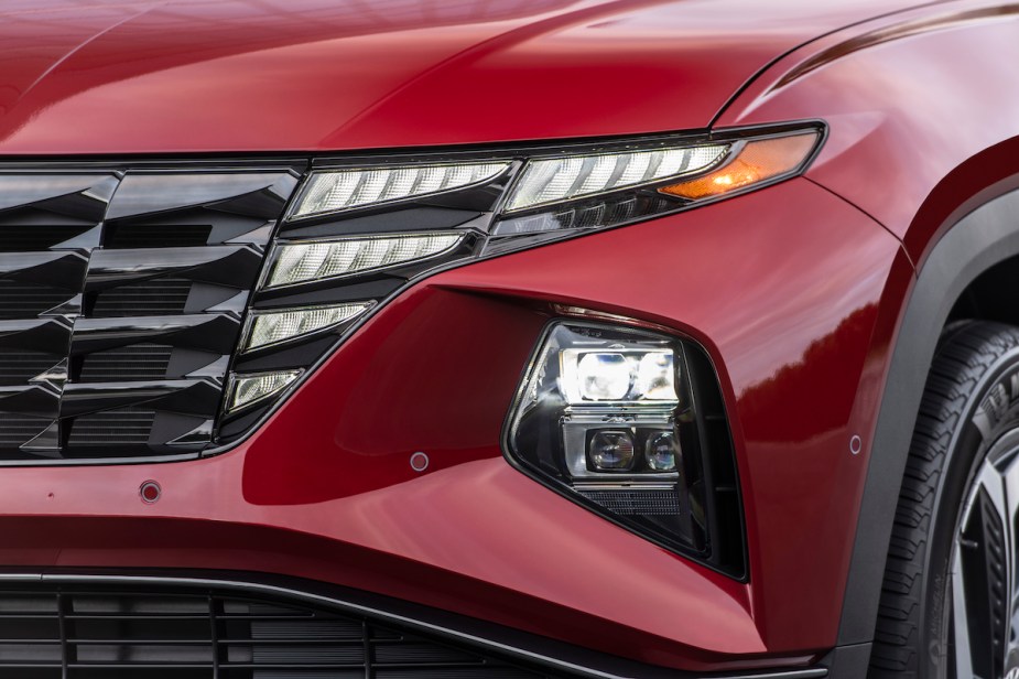 A red 2023 Hyundai Tucson headlight, which is one of the best compact plug-in hybrid SUVs.