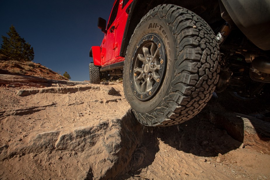 A red 2023 Jeep Wrangler, one of the best compact off-road SUVs, off-roading. 