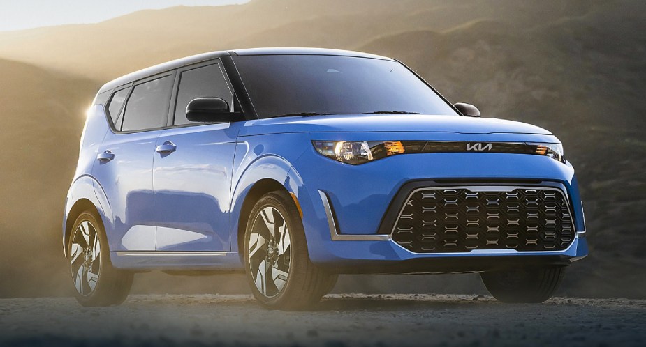 A blue 2023 Kia Soul subcompact SUV is parked. 