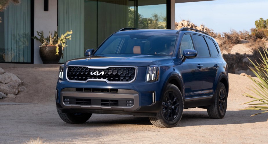 A blue 2023 Kia Telluride midsize SUV is parked. 