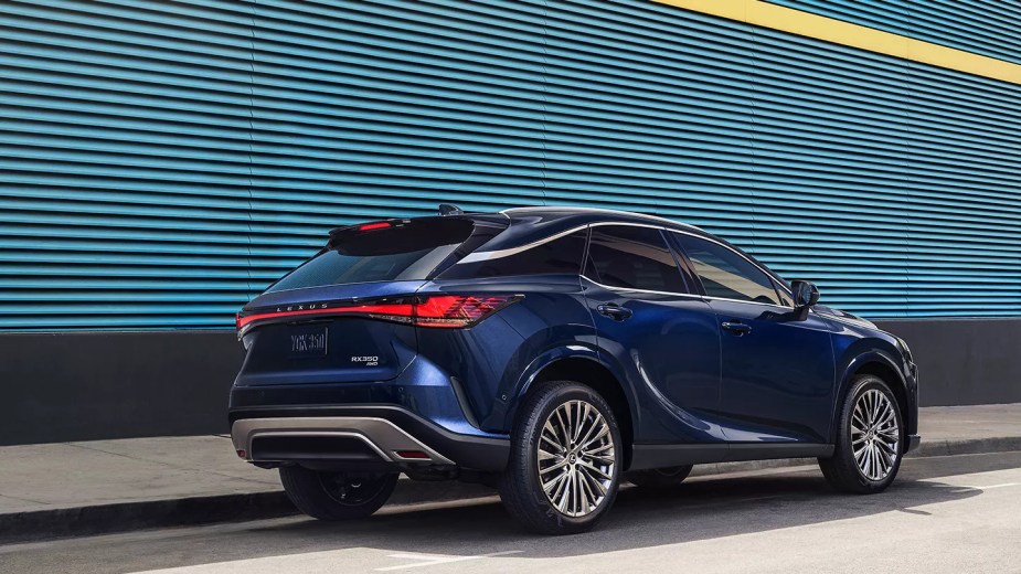 A blue 2023 Lexus RX 500h F Sport Performance AWD luxury compact SUV parked outside.