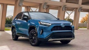 A blue 2023 Toyota RAV4 Hybrid small SUV is parked.