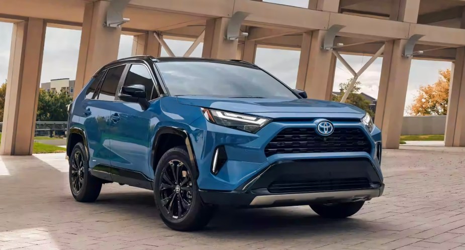 A blue 2023 Toyota RAV4 Hybrid small SUV is parked.