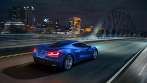 The new 2024 Chevrolet Corvette E-Ray blasts down an city bridge using its hybrid platform.