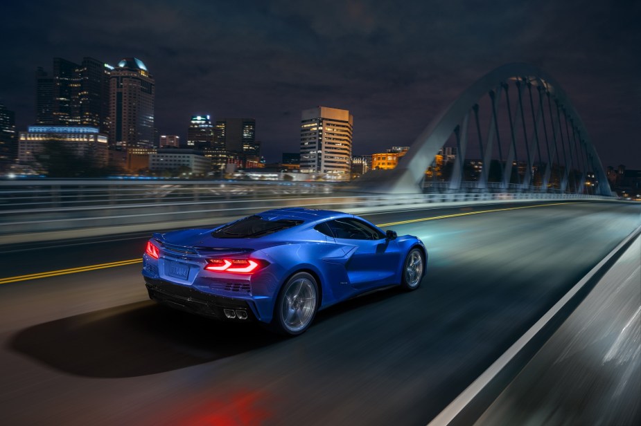 The new 2024 Chevrolet Corvette E-Ray blasts down an city bridge using its hybrid platform. 