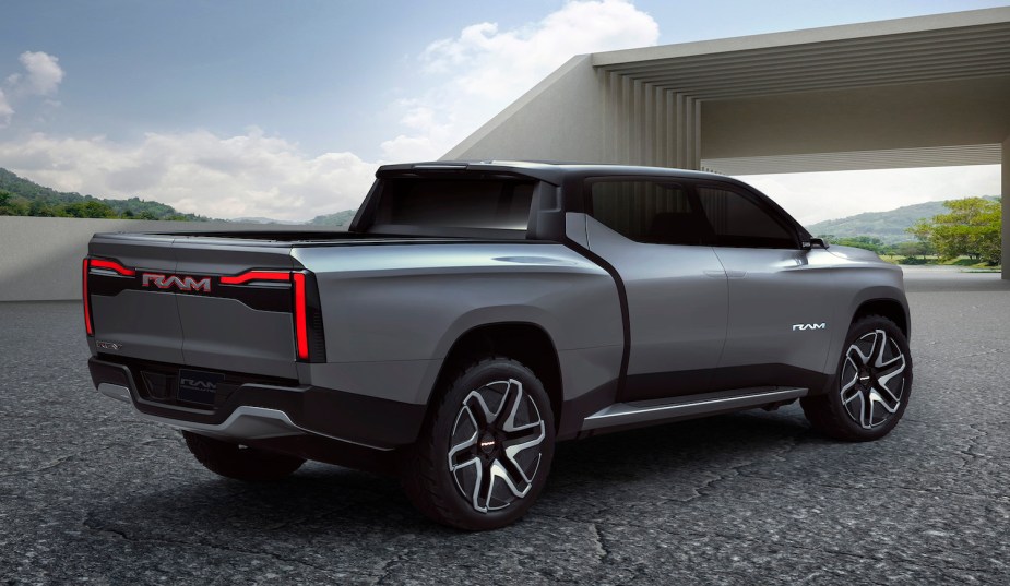 Promo render of the back of the Ram 1500 Revolution electric pickup truck concept with a modern building in the background.