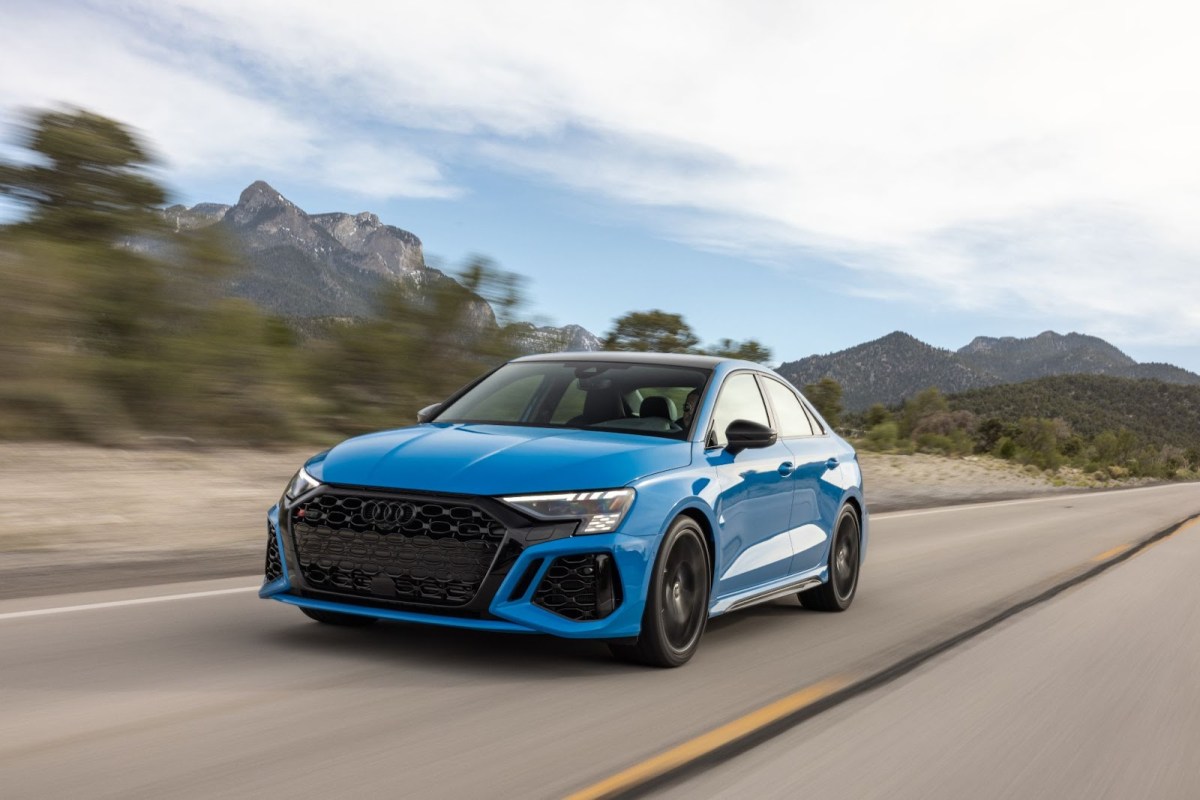 The 2023 Audi RS 3 in blue driving on a desert road