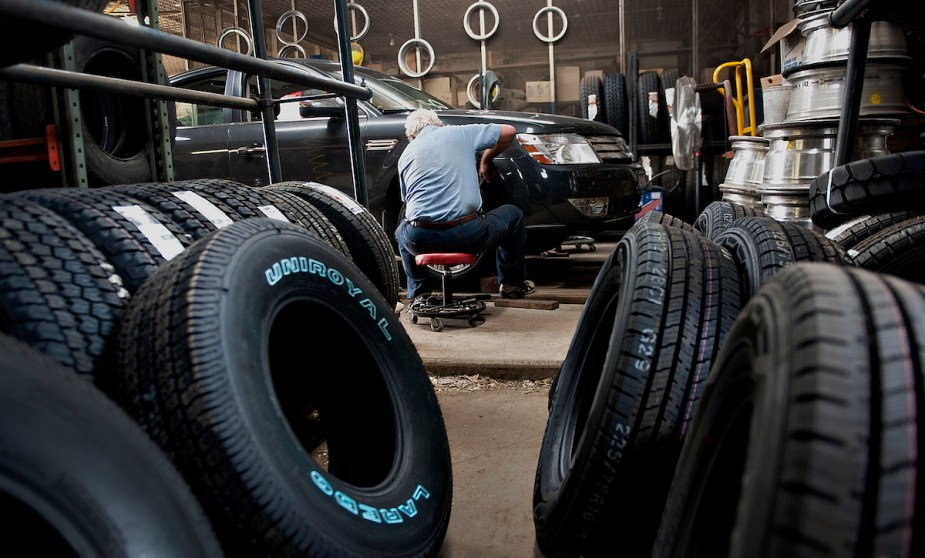 A car being maintained where people have to worry about maintenance costs. 