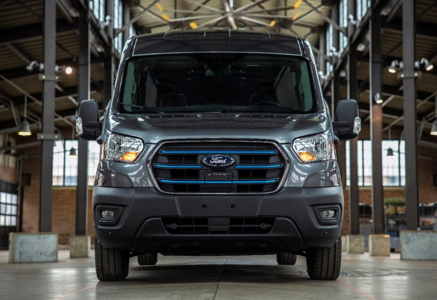 A Ford E-Transit delivery van in a warehouse.