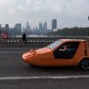 A Bond Bug three-wheeler converted EV crossing Westminster Bridge in London, United Kingdom (U.K.)