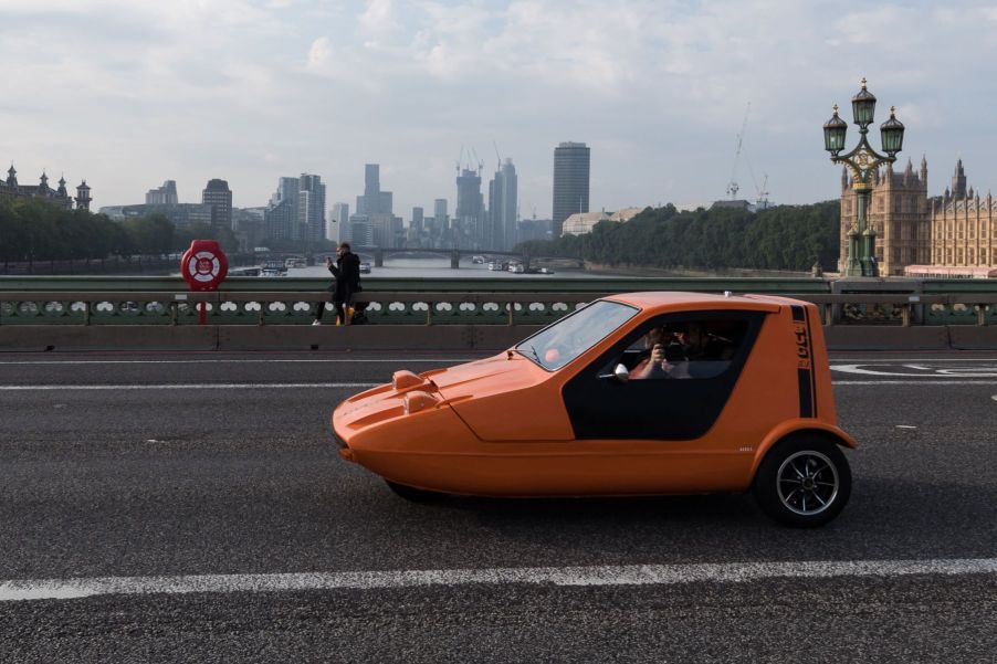 A Bond Bug three-wheeler converted EV crossing Westminster Bridge in London, United Kingdom (U.K.)