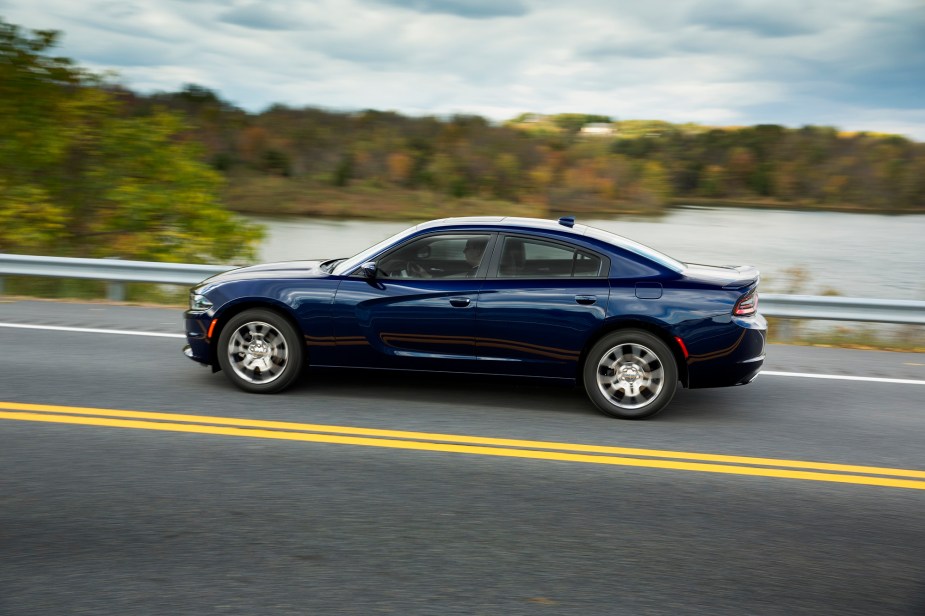 A Dodge Charger SXT drives down a highway showing off its large car proportions. 