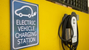 A yellow wall with an electric charging station, which is to an EV that doesn't need a transfer case.