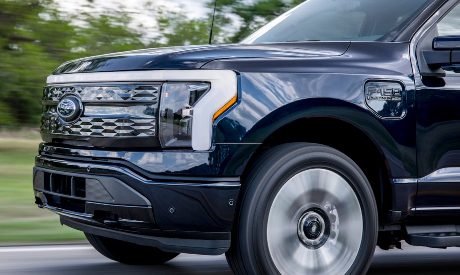 A dark blue Ford F-150 Lightning, one of the least reliable American car brands. 