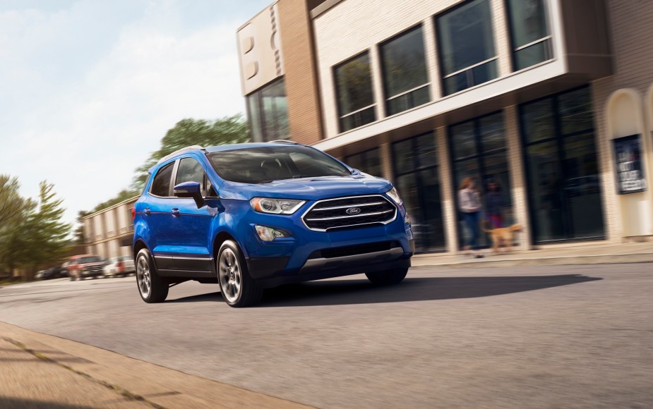 A 2022 Ford EcoSport Titanium SUV takes a corner in a city.